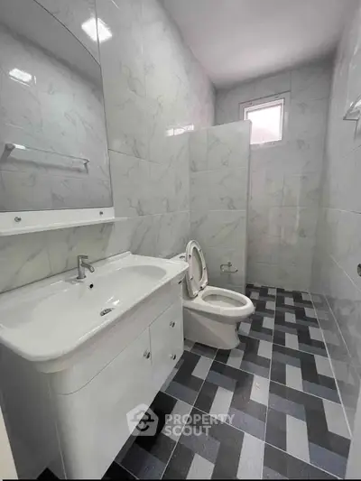Modern bathroom with sleek fixtures and stylish tile flooring, perfect for a contemporary home.