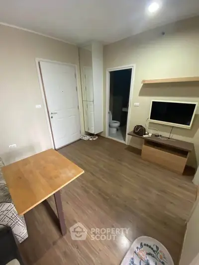 Cozy living room with wooden flooring and modern TV setup