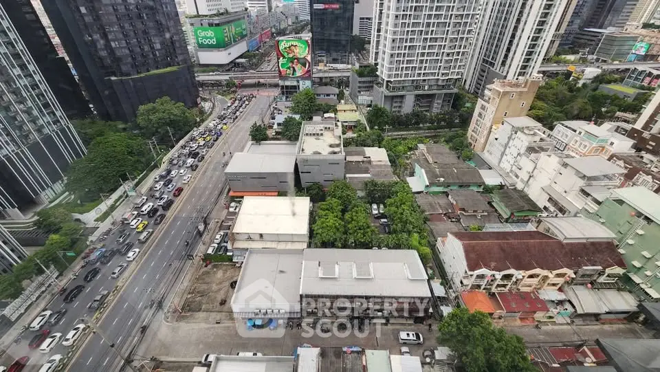 Stunning cityscape view from high-rise building showcasing urban architecture and bustling streets.