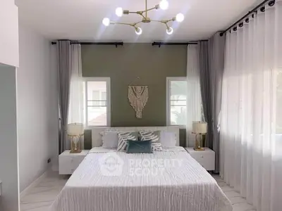 Elegant bedroom with modern decor and large windows for natural light
