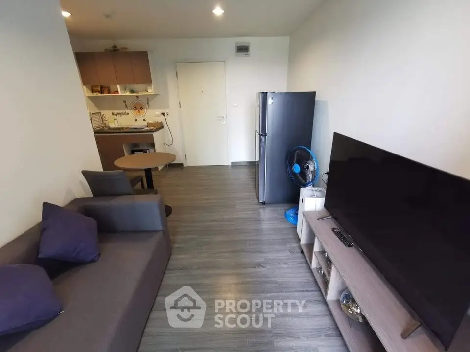 Modern living room with sleek furniture and open kitchen layout