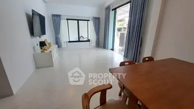 Spacious living room with modern decor and large windows for natural light.