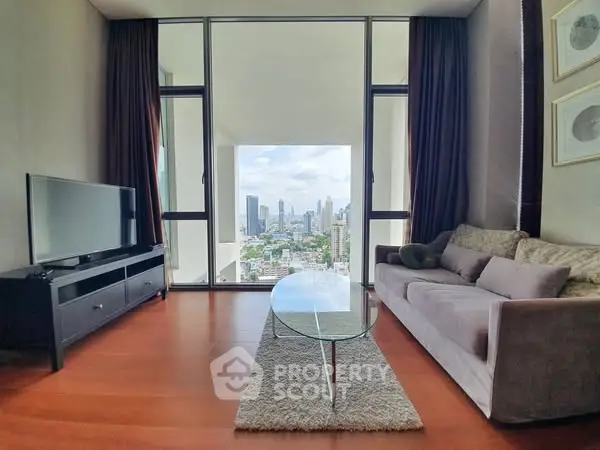 Modern living room with city view, featuring sleek furniture and floor-to-ceiling windows.