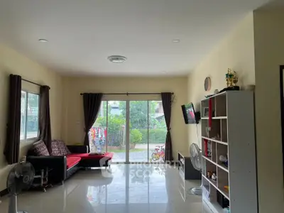 Spacious living room with modern decor and large windows offering natural light.