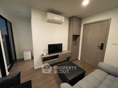Modern living room with sleek furniture and air conditioning unit