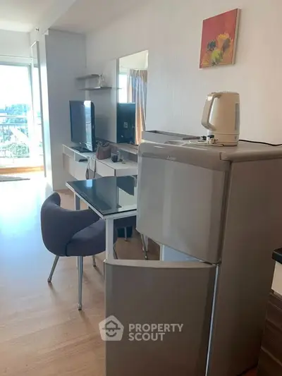 Modern apartment with open layout, featuring sleek furniture and natural light.