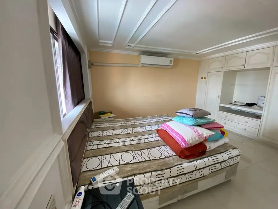 Spacious bedroom with modern design and ample natural light