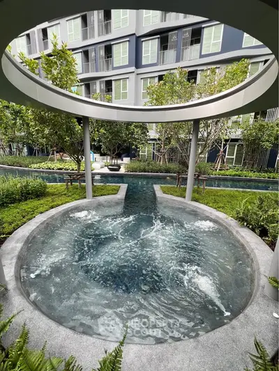Luxurious outdoor pool area with modern design and lush greenery in a high-end residential complex.