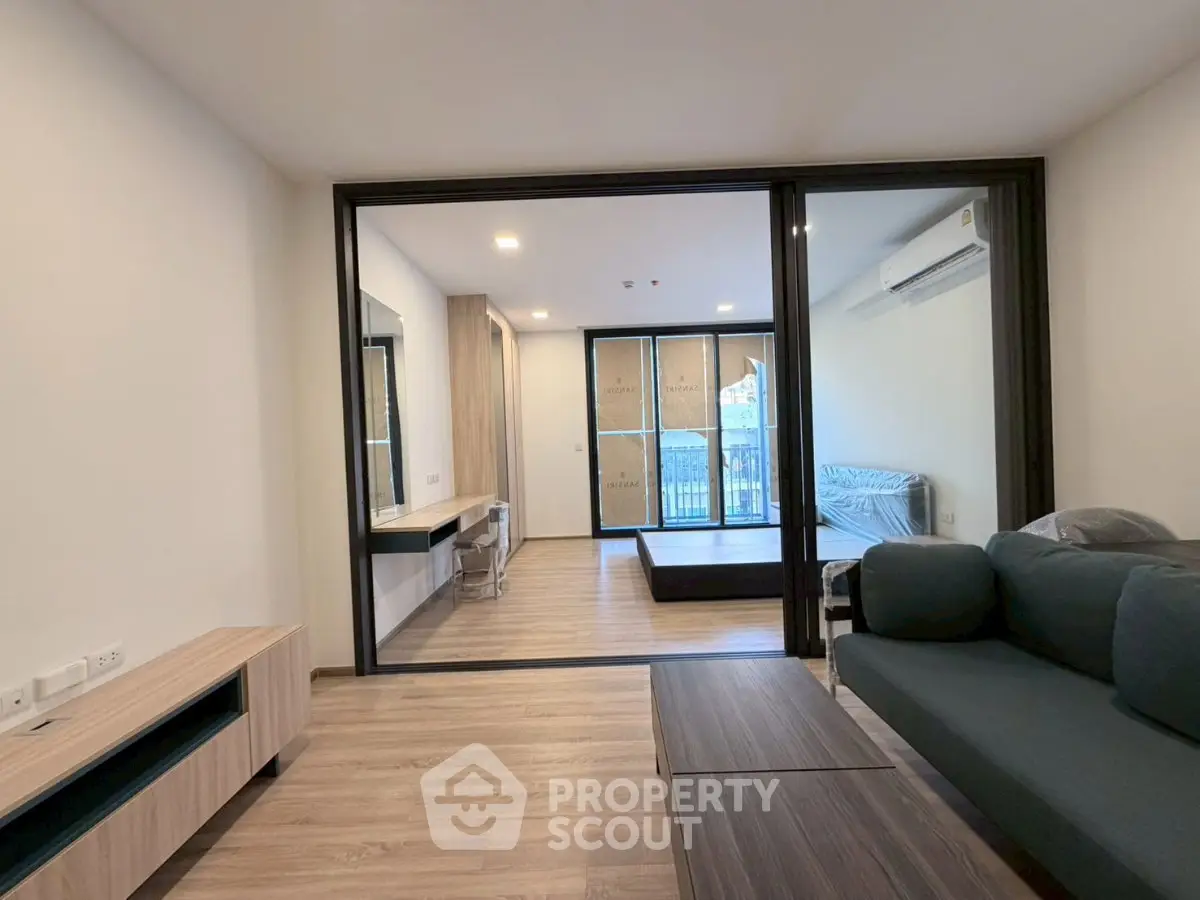 Modern living room with sleek furniture and large windows in a stylish apartment.