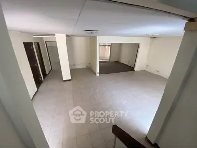 Spacious open-plan living area with tiled flooring and neutral walls, ideal for customization.