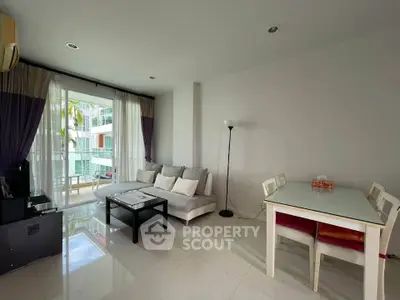 Spacious living room with modern decor and balcony access in a stylish apartment.