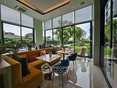 Luxurious living room with floor-to-ceiling windows and garden view