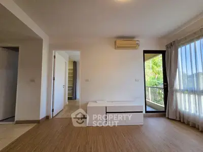 Spacious living room with balcony and natural light