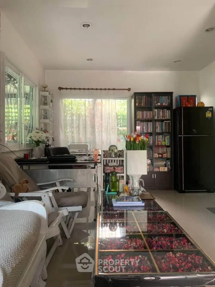 Cozy living room with modern decor and large window for natural light.