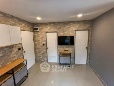 Modern living room with brick accent wall and mounted TV