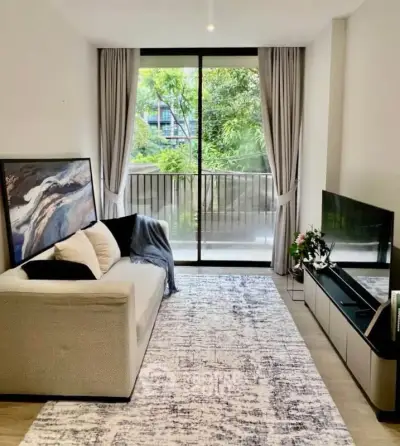Modern living room with large window and stylish decor in urban apartment
