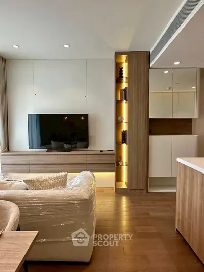 Modern living room with sleek TV unit and cozy seating area