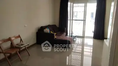 Spacious living room with modern sofa and large windows for natural light.