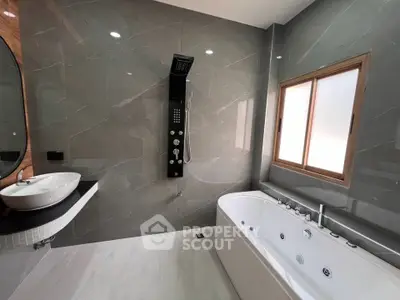 Luxurious modern bathroom with jacuzzi tub and sleek shower panel