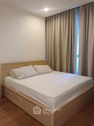 Cozy bedroom with wooden bed frame and elegant curtains