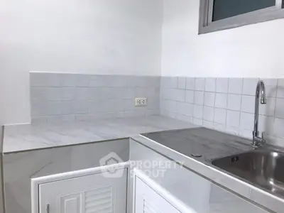 Modern kitchen with sleek marble countertops and stainless steel sink