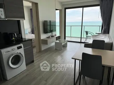 Modern beachfront apartment with open living area and stunning ocean view.