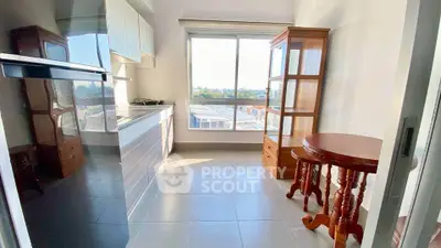 Bright kitchen with modern appliances and large window offering scenic views.