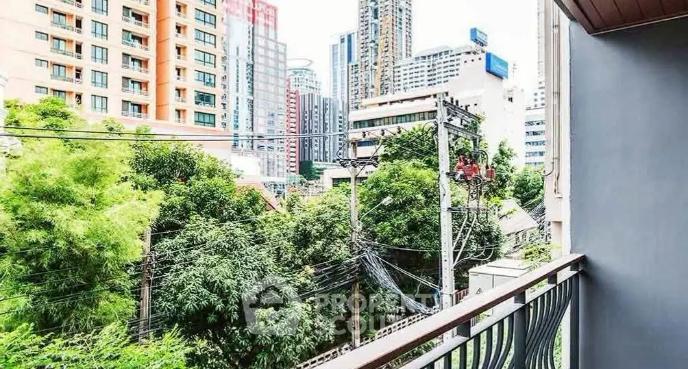 Urban balcony view with lush greenery and city skyline