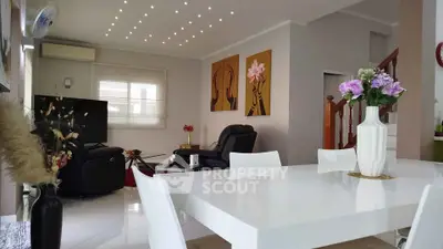 Elegant living room with modern decor and stylish dining area