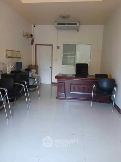 Modern office space with sleek furniture and ample natural light, perfect for productivity.