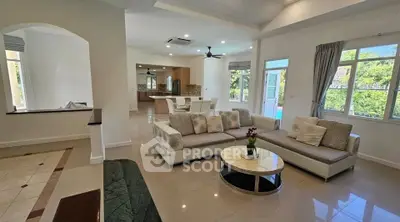 Spacious open-plan living room with modern decor and natural light