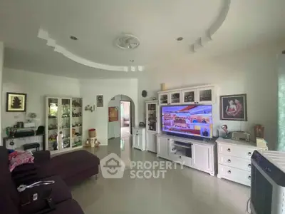 Spacious living room with modern decor and large TV unit