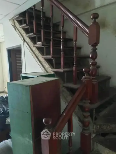 Rustic wooden staircase in need of renovation, showcasing potential for transformation.