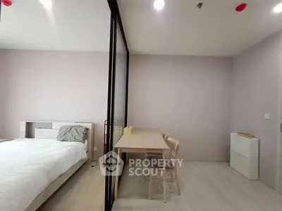 Modern bedroom with study area and glass partition in minimalist apartment