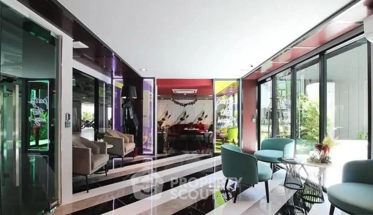 Modern lobby with stylish seating and vibrant decor in a luxury building.