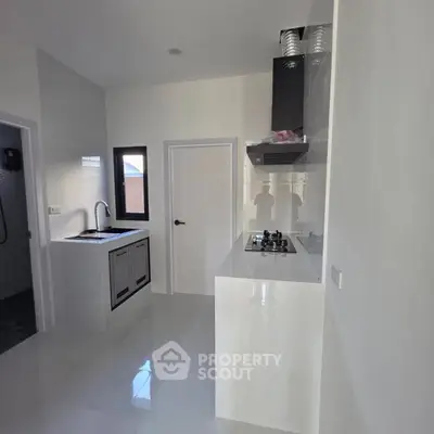 Modern kitchen with sleek white cabinetry and built-in gas stove
