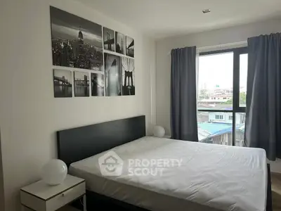 Modern bedroom with cityscape artwork and large window view