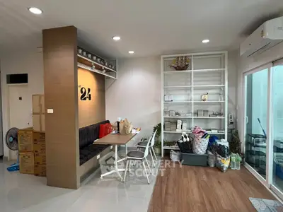 Modern living room with built-in seating and shelving, featuring sleek design and ample storage space.