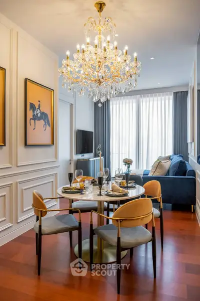 Luxurious dining area with elegant chandelier and stylish decor in modern apartment.