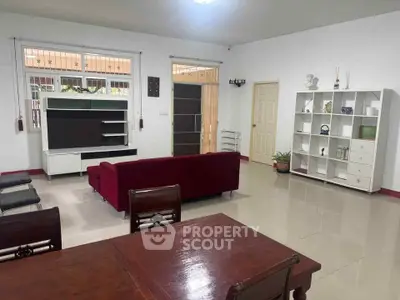 Spacious living room with modern furniture and elegant decor, perfect for family gatherings.