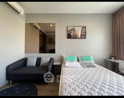 Modern bedroom with cozy sofa and stylish decor in a bright apartment.