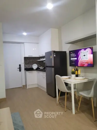 Modern compact kitchen with dining area in stylish apartment
