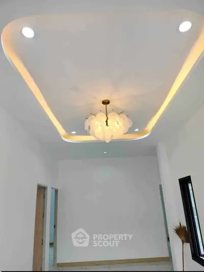 Elegant modern living room with stylish ceiling lighting and minimalist decor.