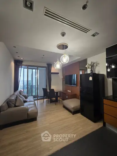 Modern living room with sleek furniture and city view balcony