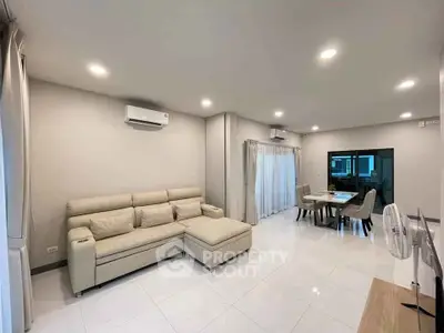 Spacious modern living room with elegant dining area and neutral tones