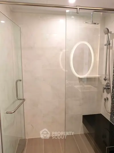 Modern bathroom with glass shower enclosure and elegant fixtures