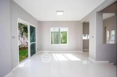 Spacious modern living room with large windows and garden view