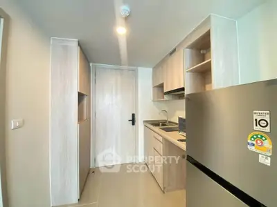 Modern kitchen with sleek cabinetry and stainless steel appliances in a compact layout.