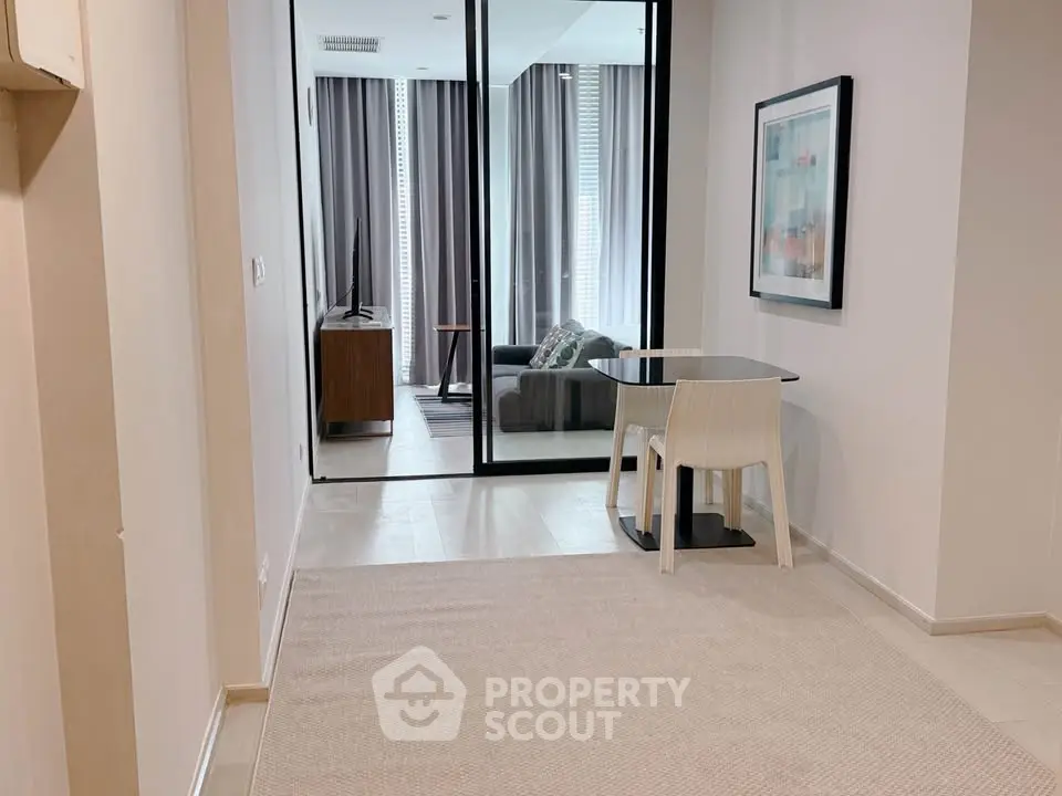 Modern apartment hallway leading to a cozy living room with stylish decor.