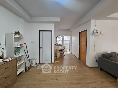 Spacious living room with wooden flooring and modern decor in a cozy apartment.